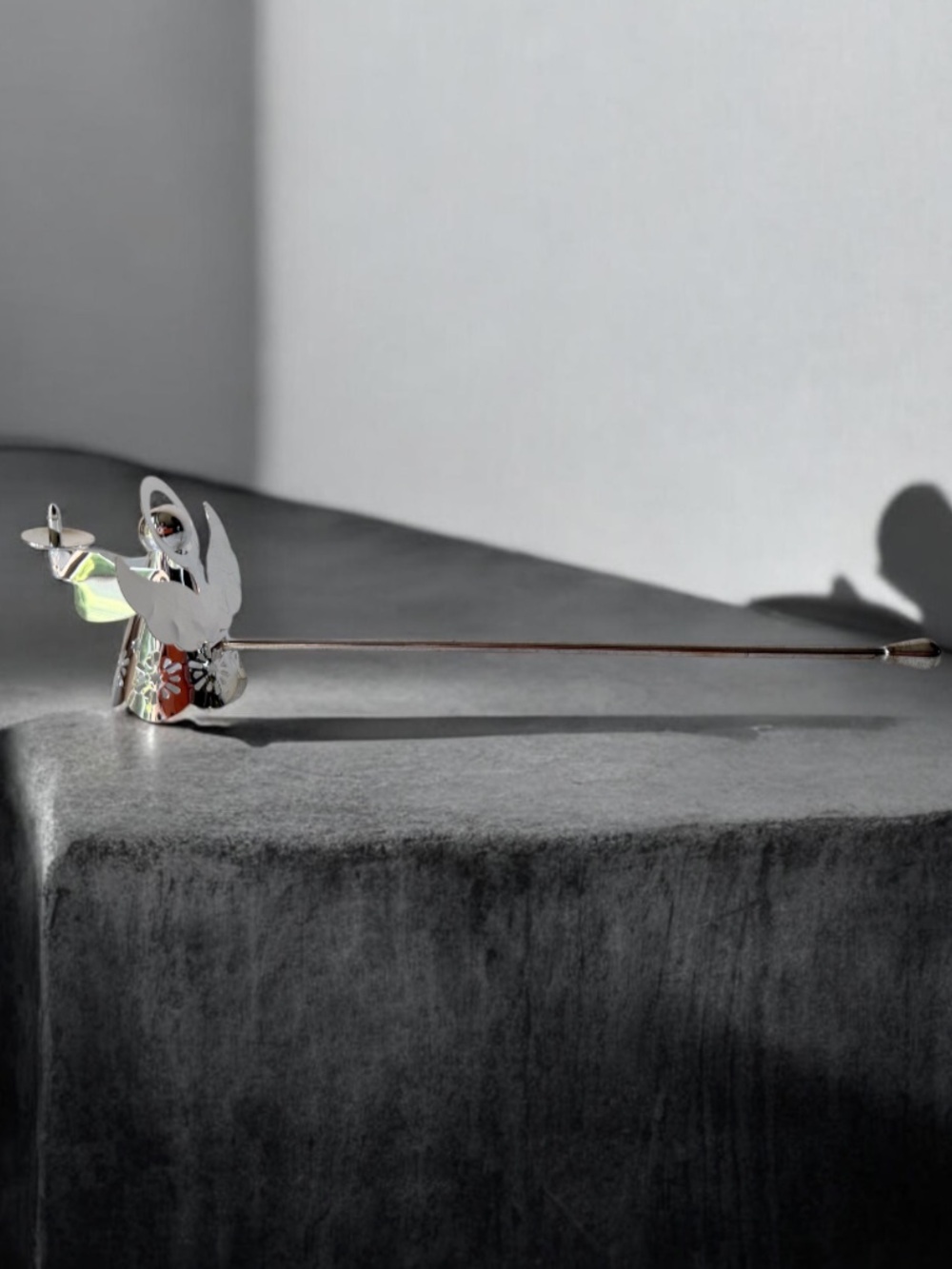 silver-tone angel candle snuffer features intricate, cutout wing and robe